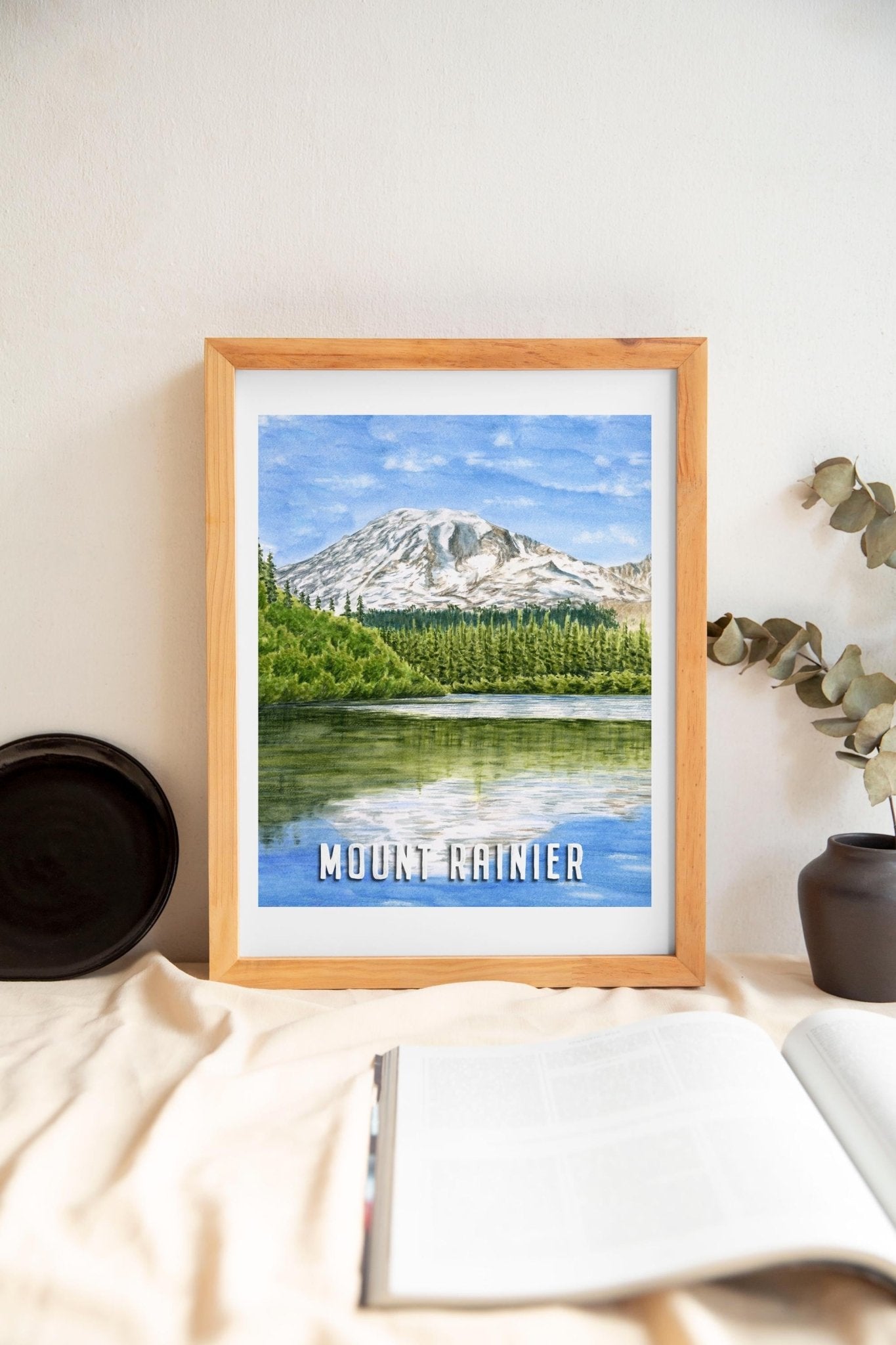Watercolor painting of Mount Rainier reflecting on a lake in a poster print