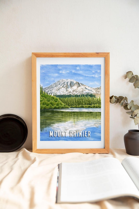 Watercolor painting of Mount Rainier reflecting on a lake in a poster print